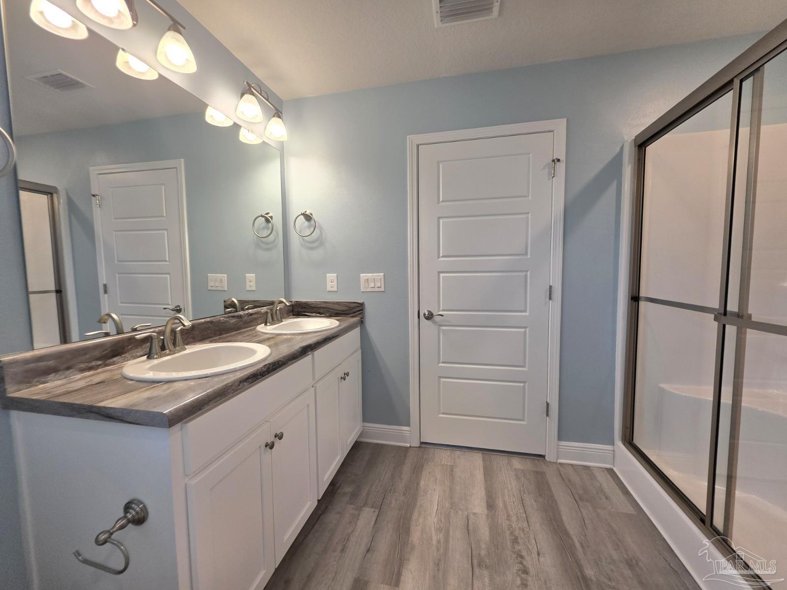 5031 Firstmate Way Pensacola, FL 32526 - Photo 13 of 27 a bathroom with a sink a mirror and a shower