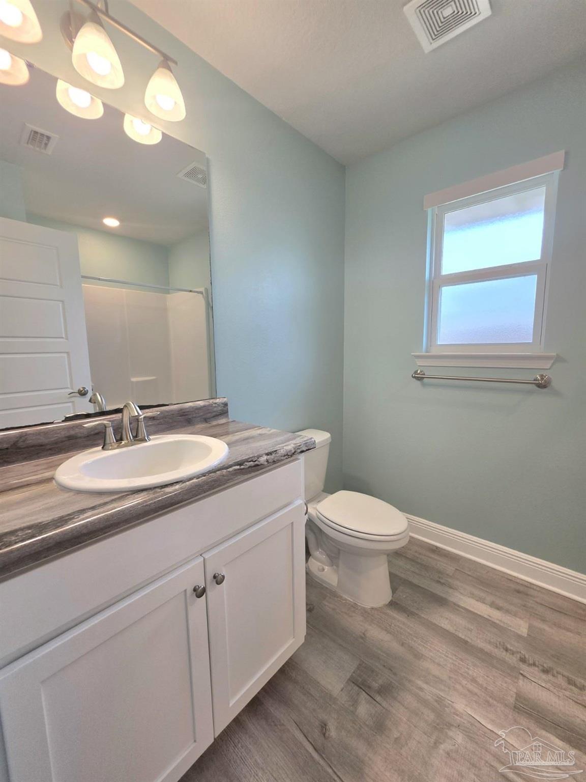 5031 Firstmate Way Pensacola, FL 32526 - Photo 19 of 27 a bathroom with a toilet a sink and mirror