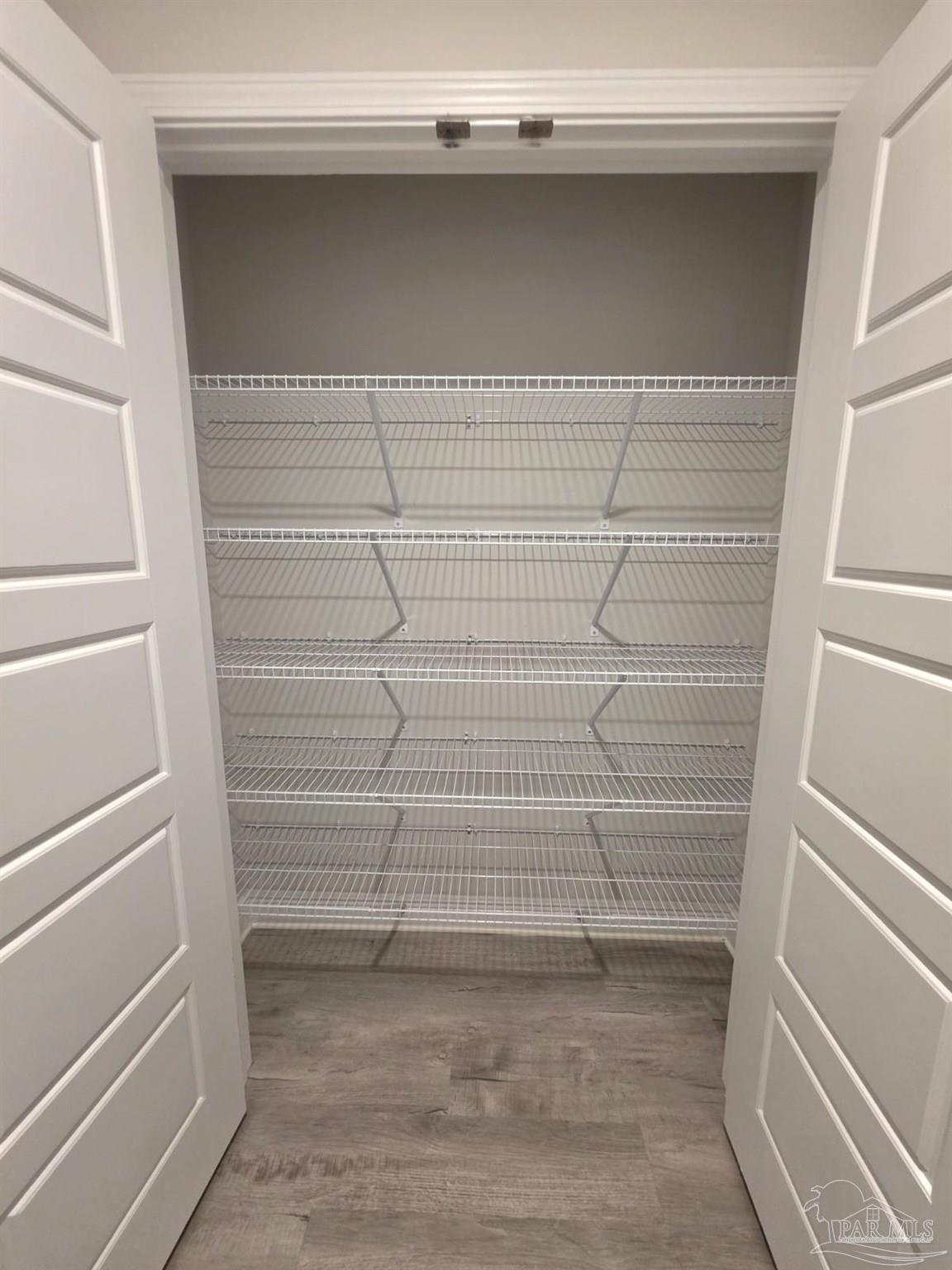 5031 Firstmate Way Pensacola, FL 32526 - Photo 23 of 27 a view of walk in closet with empty racks