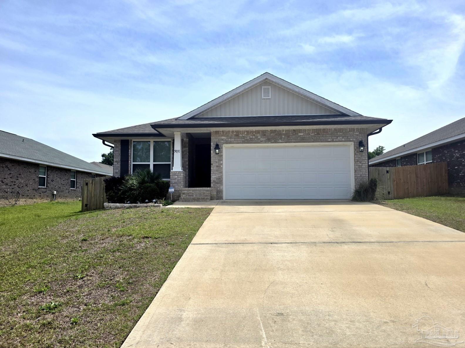 5031 Firstmate Way Pensacola, FL 32526 - Photo 27 of 27 a front view of a house with a yard and garage