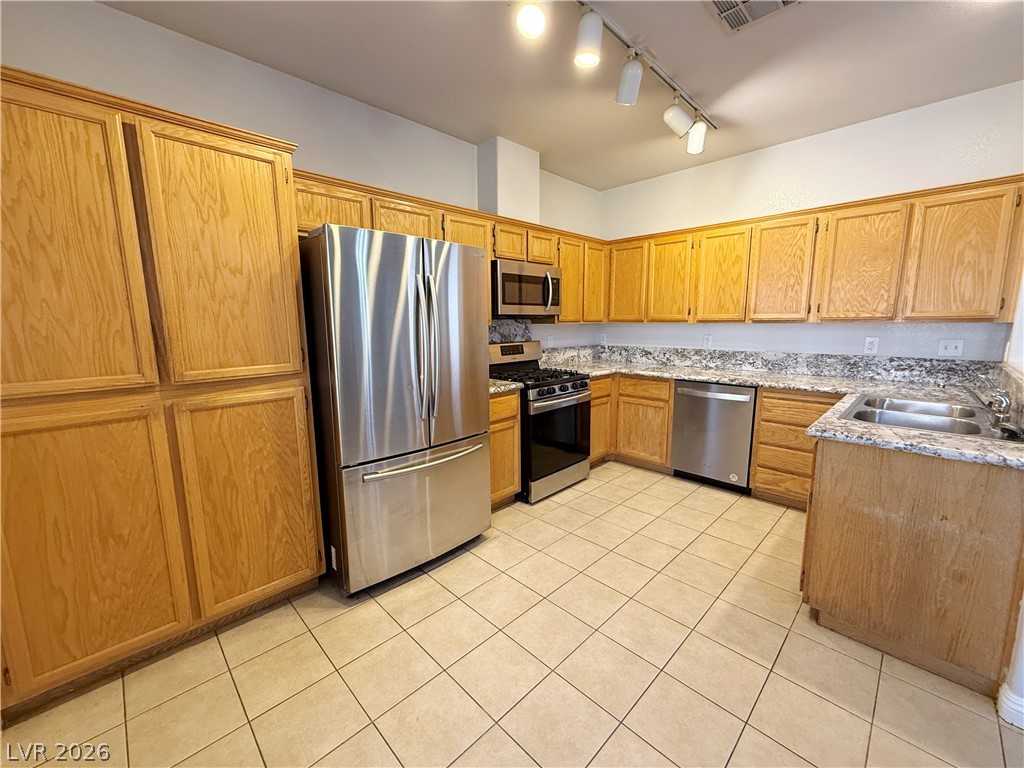 2185 Polynesia Circle Henderson, NV 89074 - Photo 11 of 37 Functional kitchen with ample cabinetry and robust stainless steel appliances.