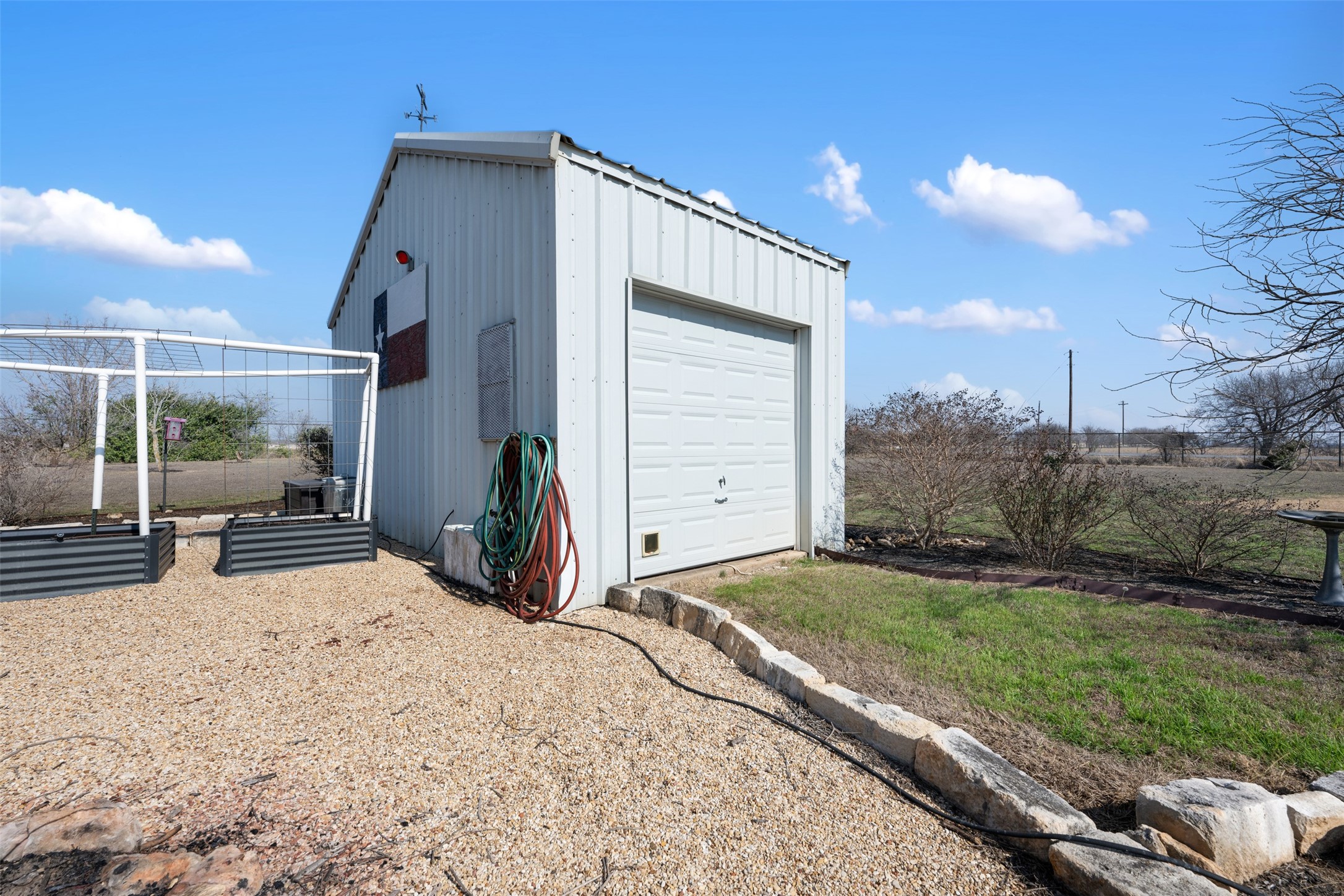 6501 County Road 239 Jarrell, TX 76537 - Photo 32 of 40 well house holds the well equipment, whole house water filtration equipment, and a 2500+ gallon water storage tank; 3 raised garden beds also have pvc piping to hold a shade sail