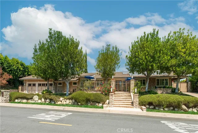 a front view of a house with a garden