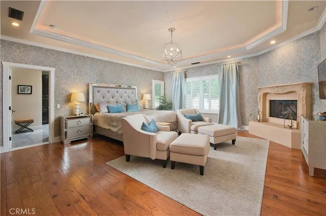 a bedroom with a bed and chandelier