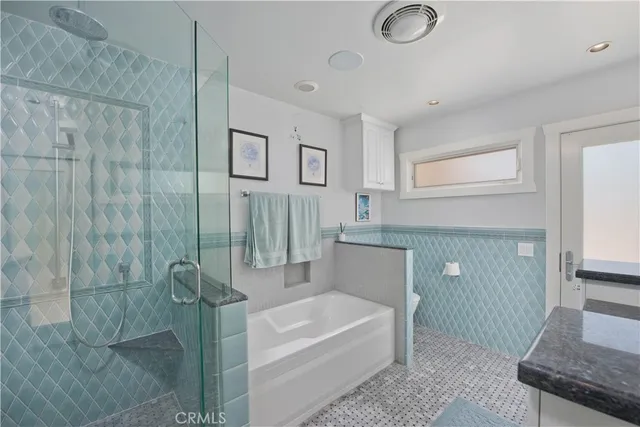 a bathroom with a shower and a sink