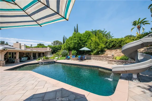 a view of a patio with plants and chairs