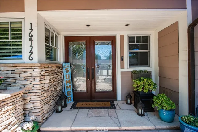 a view of front door of house with potted plant