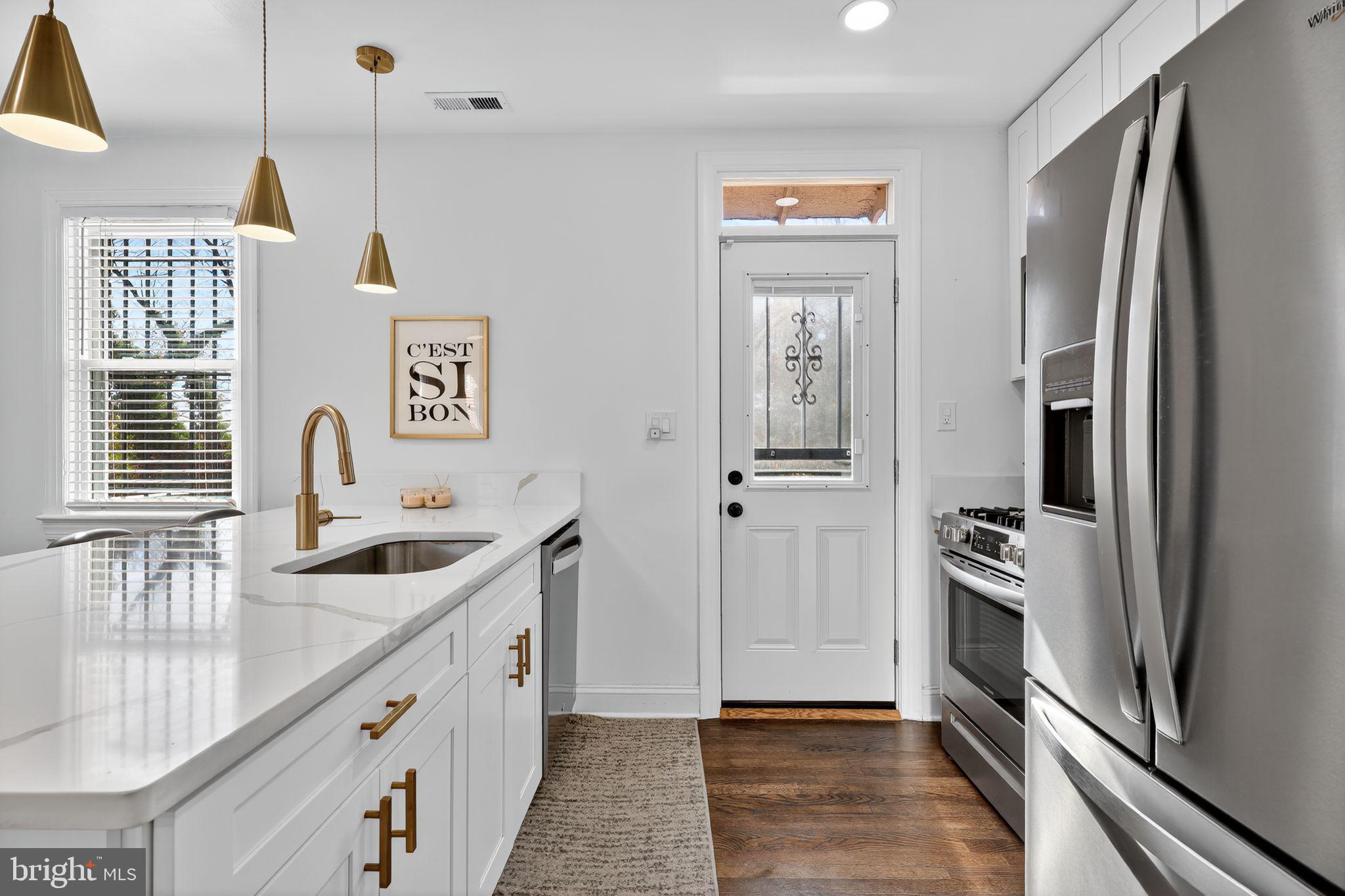 3947 S Street Southeast Washington, DC 20020 - Photo 13 of 28 a kitchen with stainless steel appliances granite countertop a refrigerator and a sink