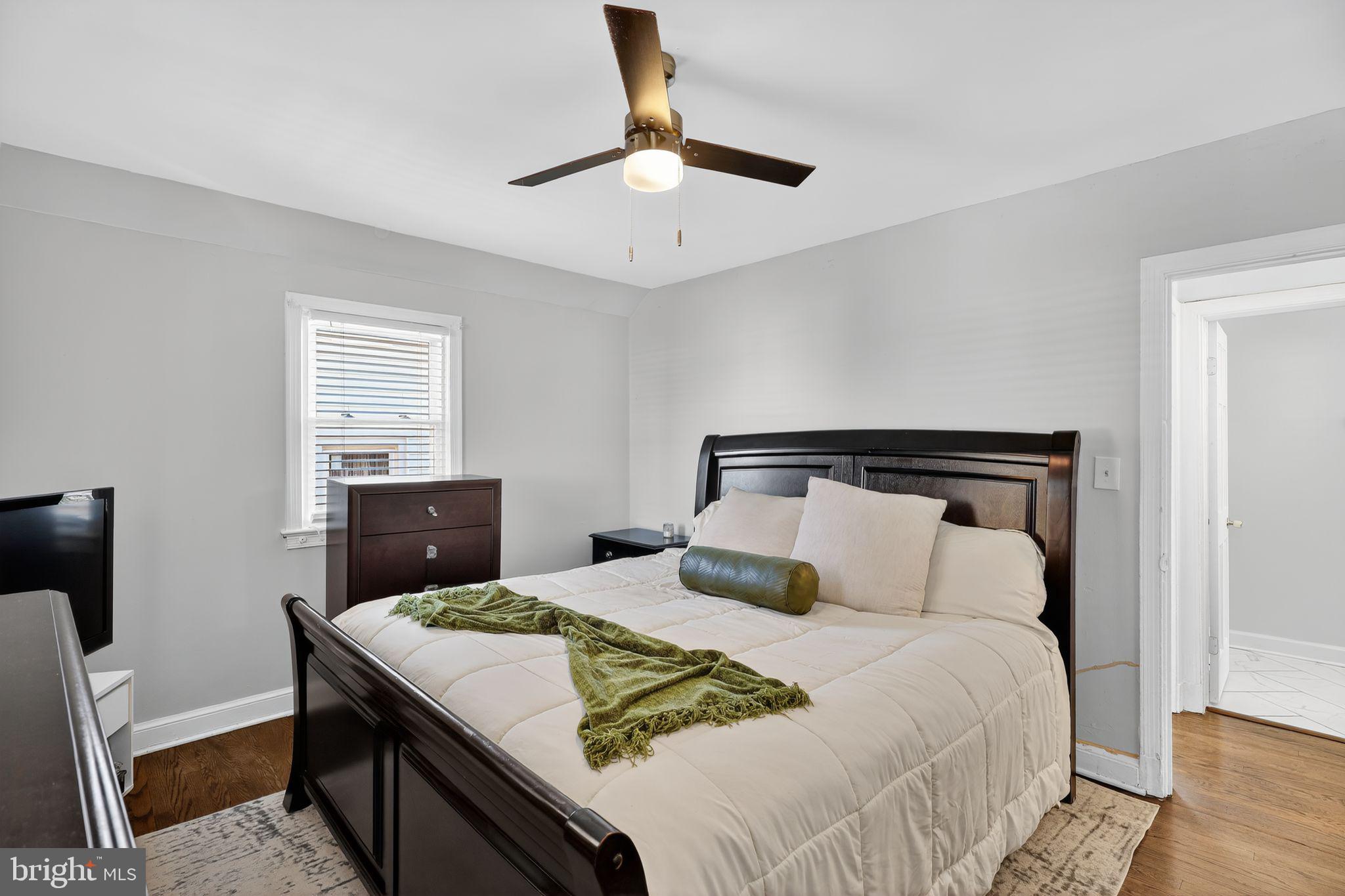 3947 S Street Southeast Washington, DC 20020 - Photo 19 of 28 a bedroom with a bed and a chandelier