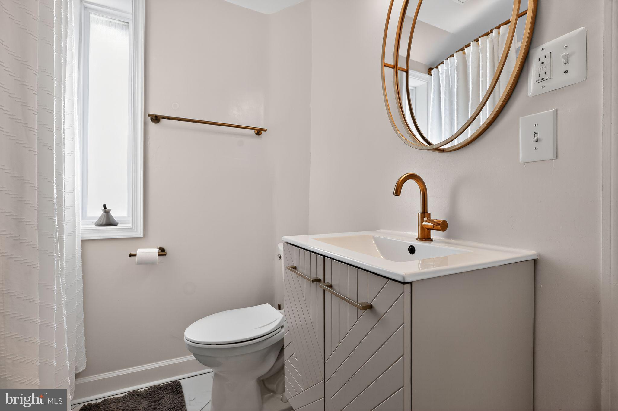 3947 S Street Southeast Washington, DC 20020 - Photo 21 of 28 a bathroom with a sink a toilet and a mirror