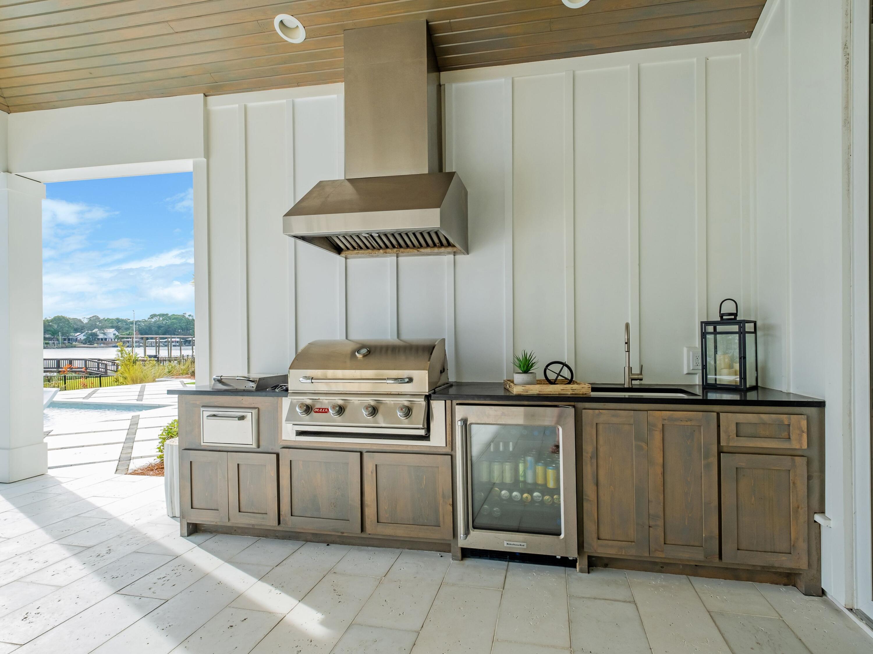 336 East Shipwreck Road Santa Rosa Beach, FL 32459 - Photo 15 of 54 a kitchen with a stove a sink and cabinets