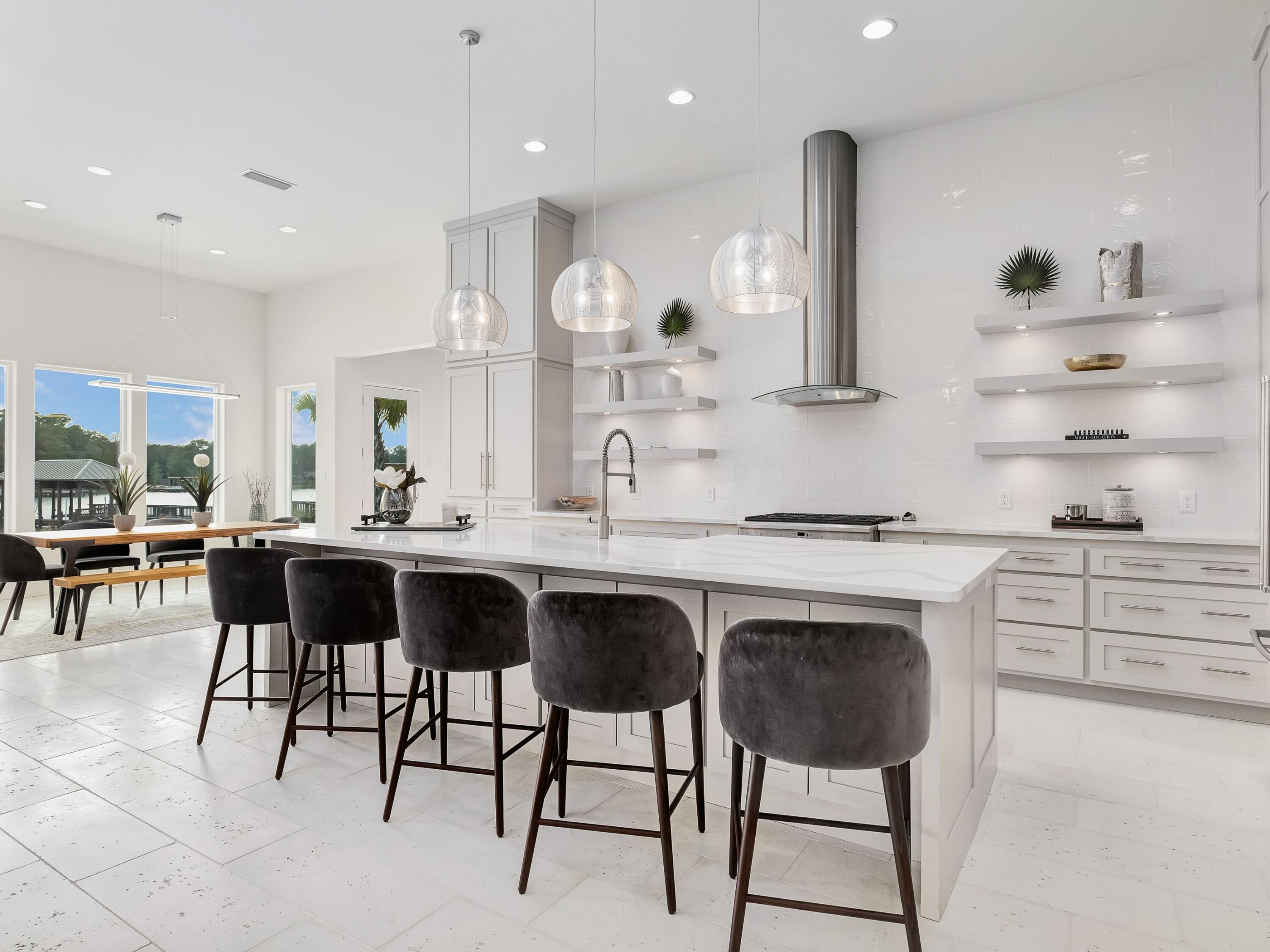 336 East Shipwreck Road Santa Rosa Beach, FL 32459 - Photo 18 of 54 a kitchen with a dining table chairs cabinets and stainless steel appliances