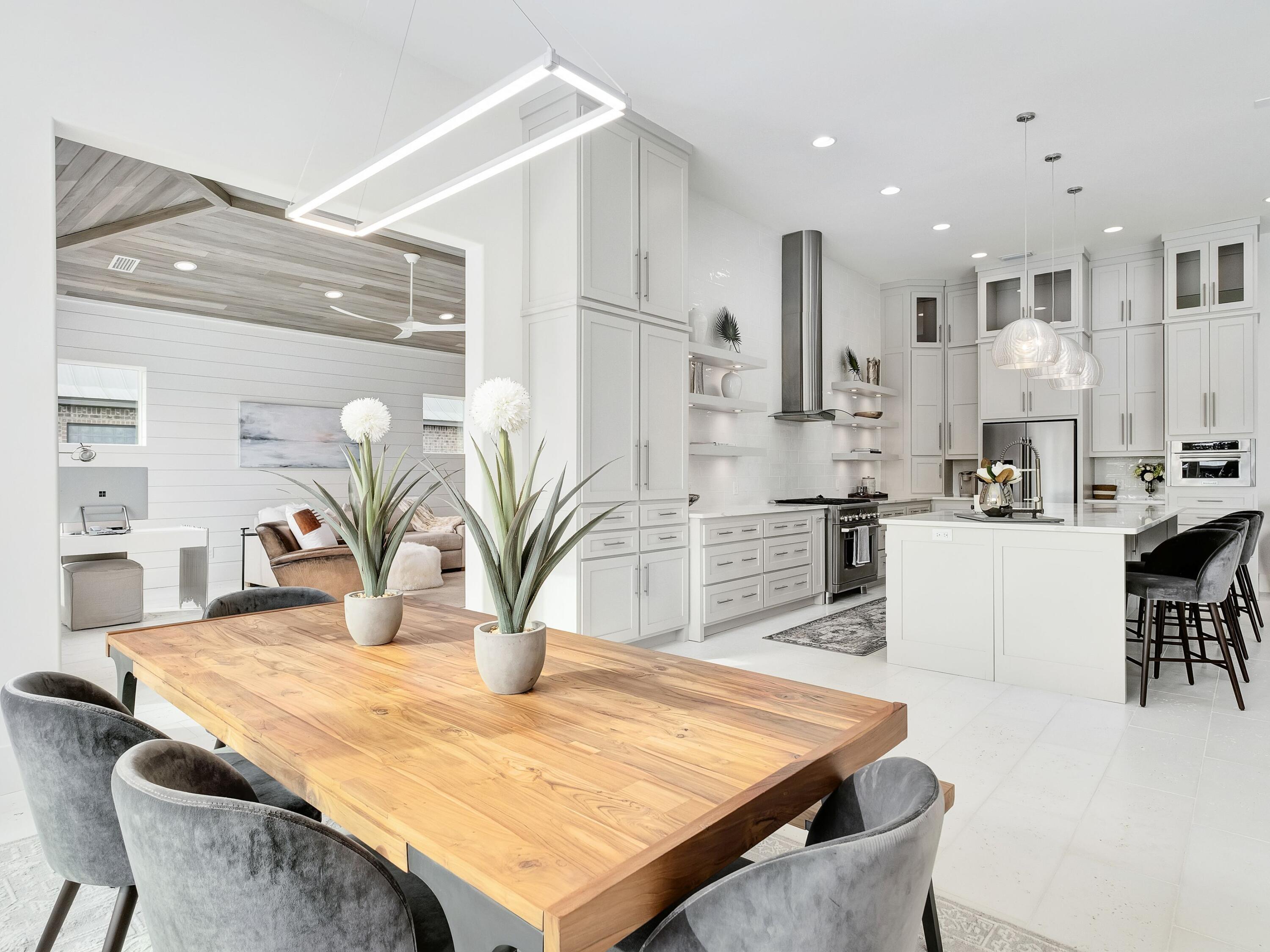 336 East Shipwreck Road Santa Rosa Beach, FL 32459 - Photo 19 of 54 a kitchen with kitchen island a stove a sink a dining table and chairs
