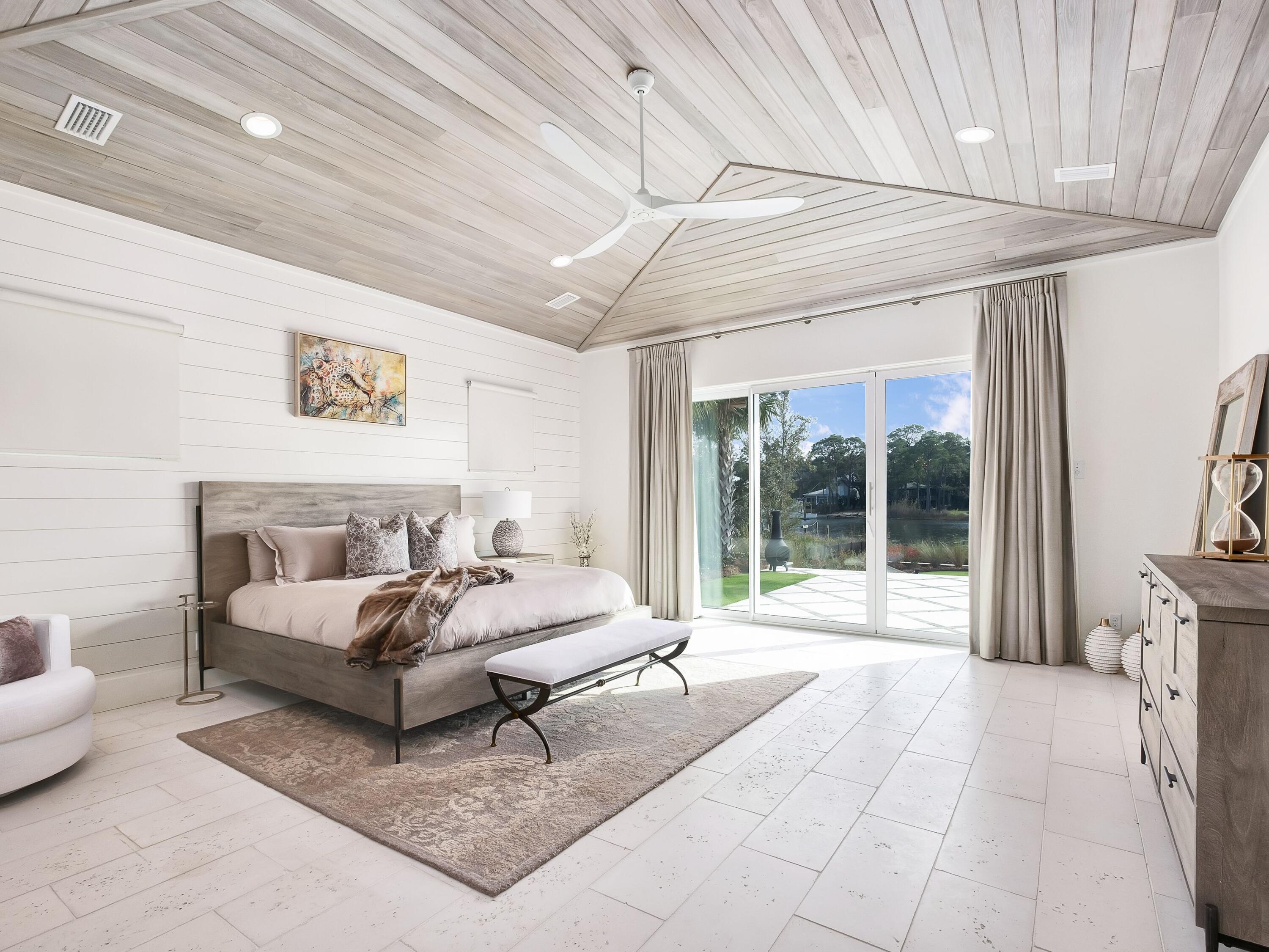 336 East Shipwreck Road Santa Rosa Beach, FL 32459 - Photo 24 of 54 a spacious bedroom with a bed couch and a large window