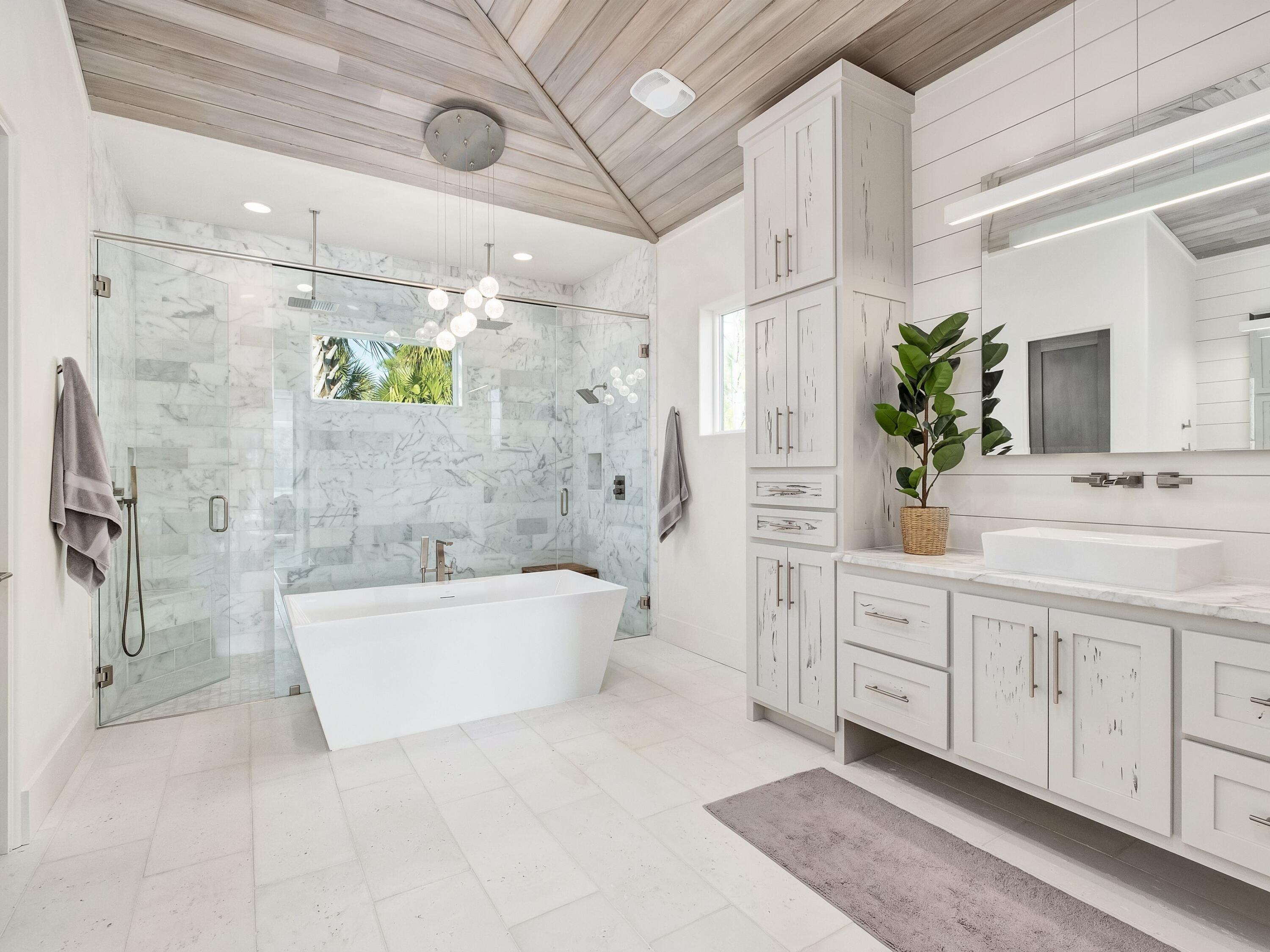 336 East Shipwreck Road Santa Rosa Beach, FL 32459 - Photo 26 of 54 a spacious bathroom with a double vanity sink a mirror a bathtub and a shower