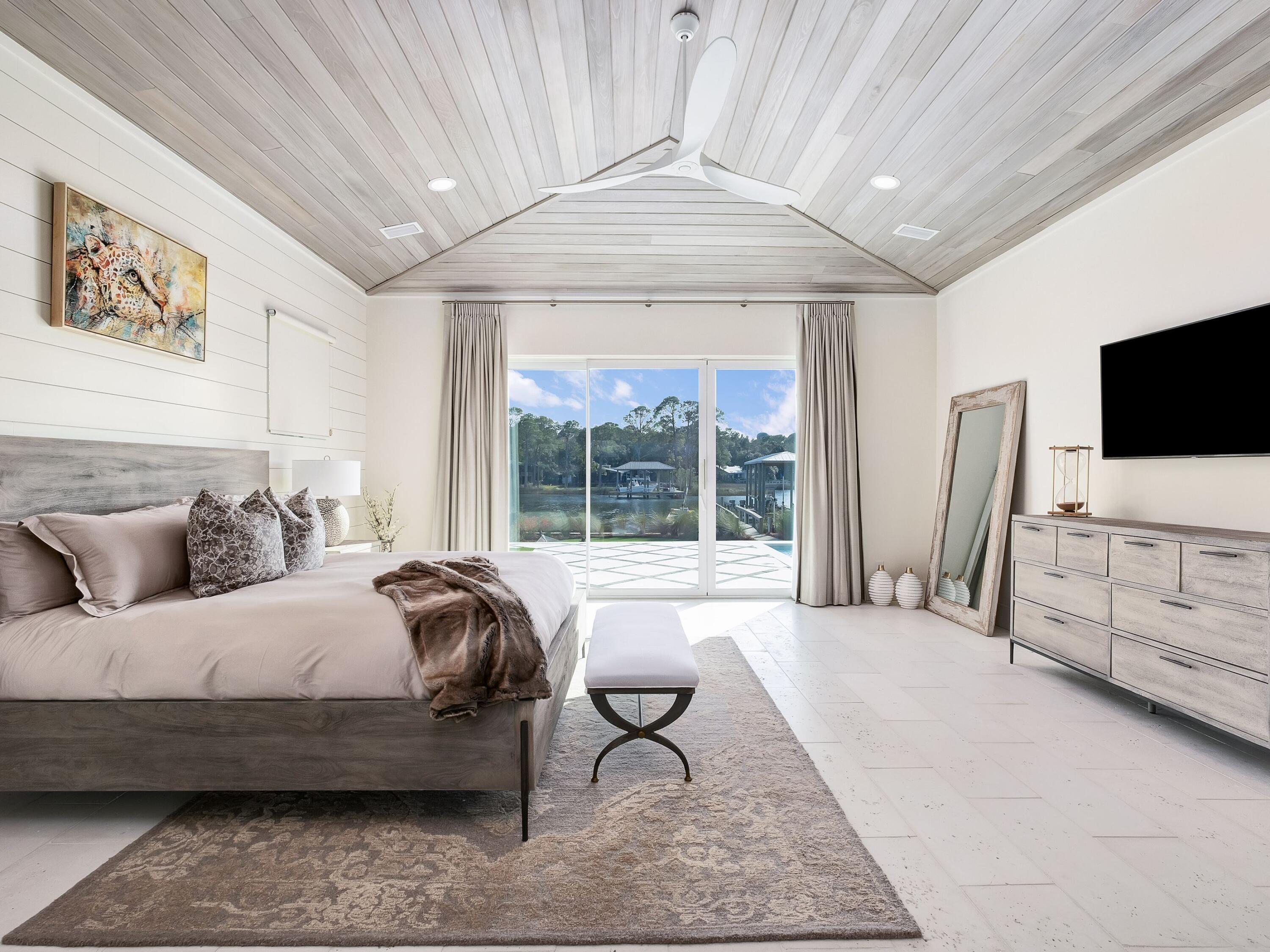 336 East Shipwreck Road Santa Rosa Beach, FL 32459 - Photo 29 of 54 a spacious bedroom with a bed and a flat tv screen