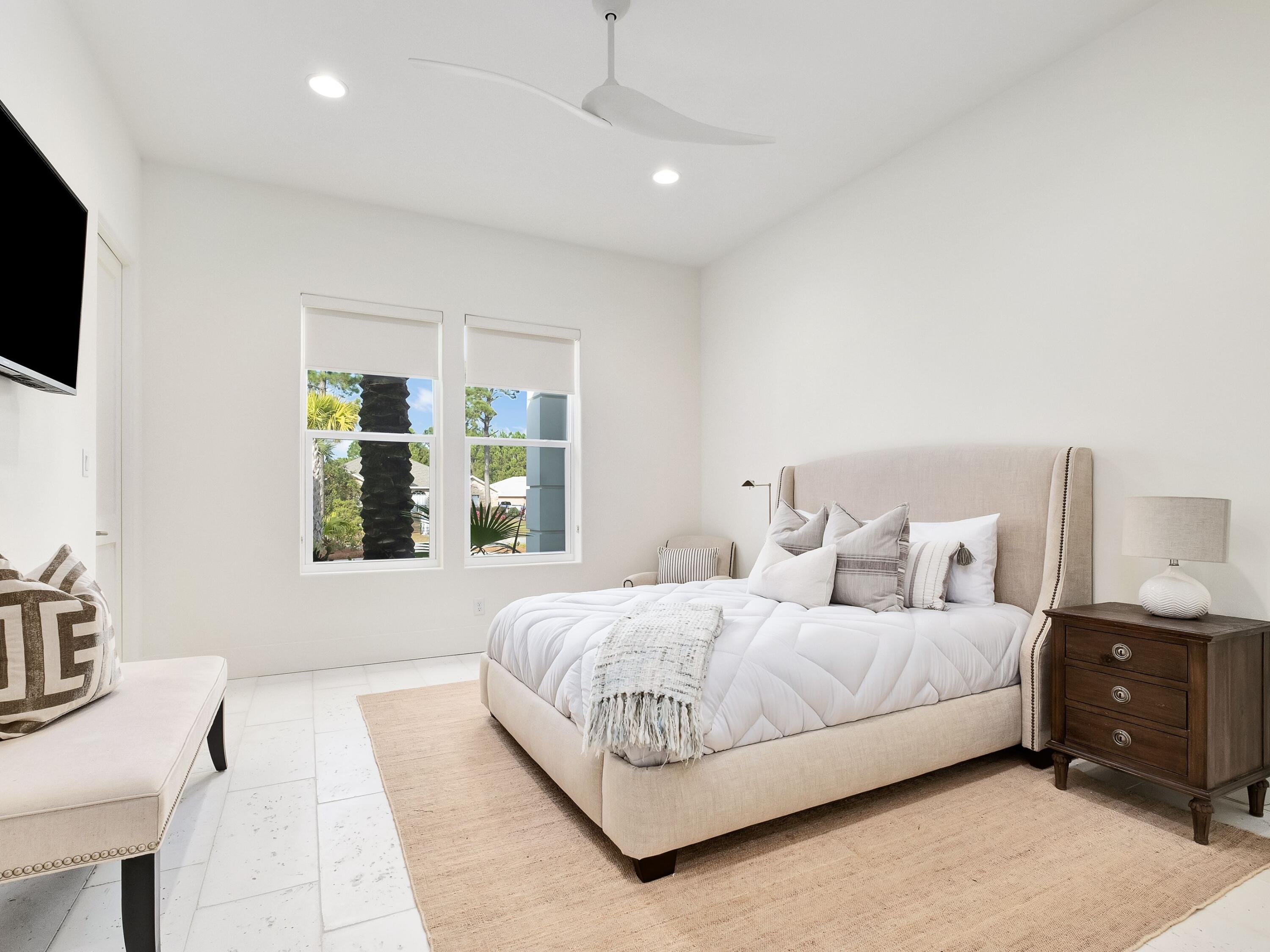 336 East Shipwreck Road Santa Rosa Beach, FL 32459 - Photo 31 of 54 a bedroom with a large bed and a flat tv screen on dresser