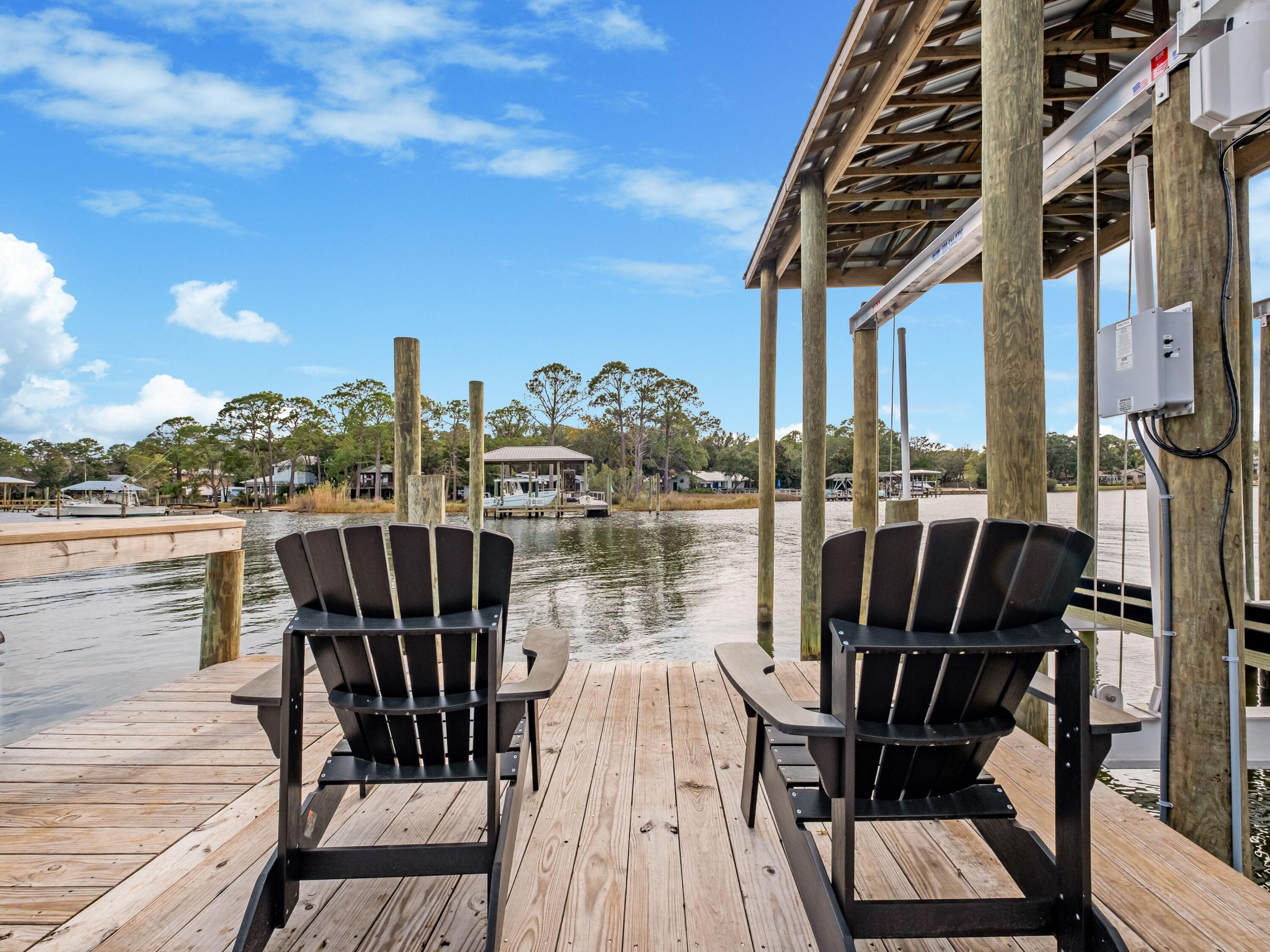 336 East Shipwreck Road Santa Rosa Beach, FL 32459 - Photo 41 of 54 a view of a balcony with chairs and wooden floor