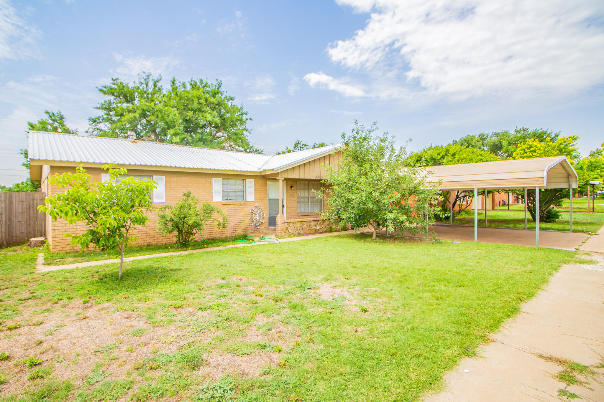 a view of house with backyard and a garden