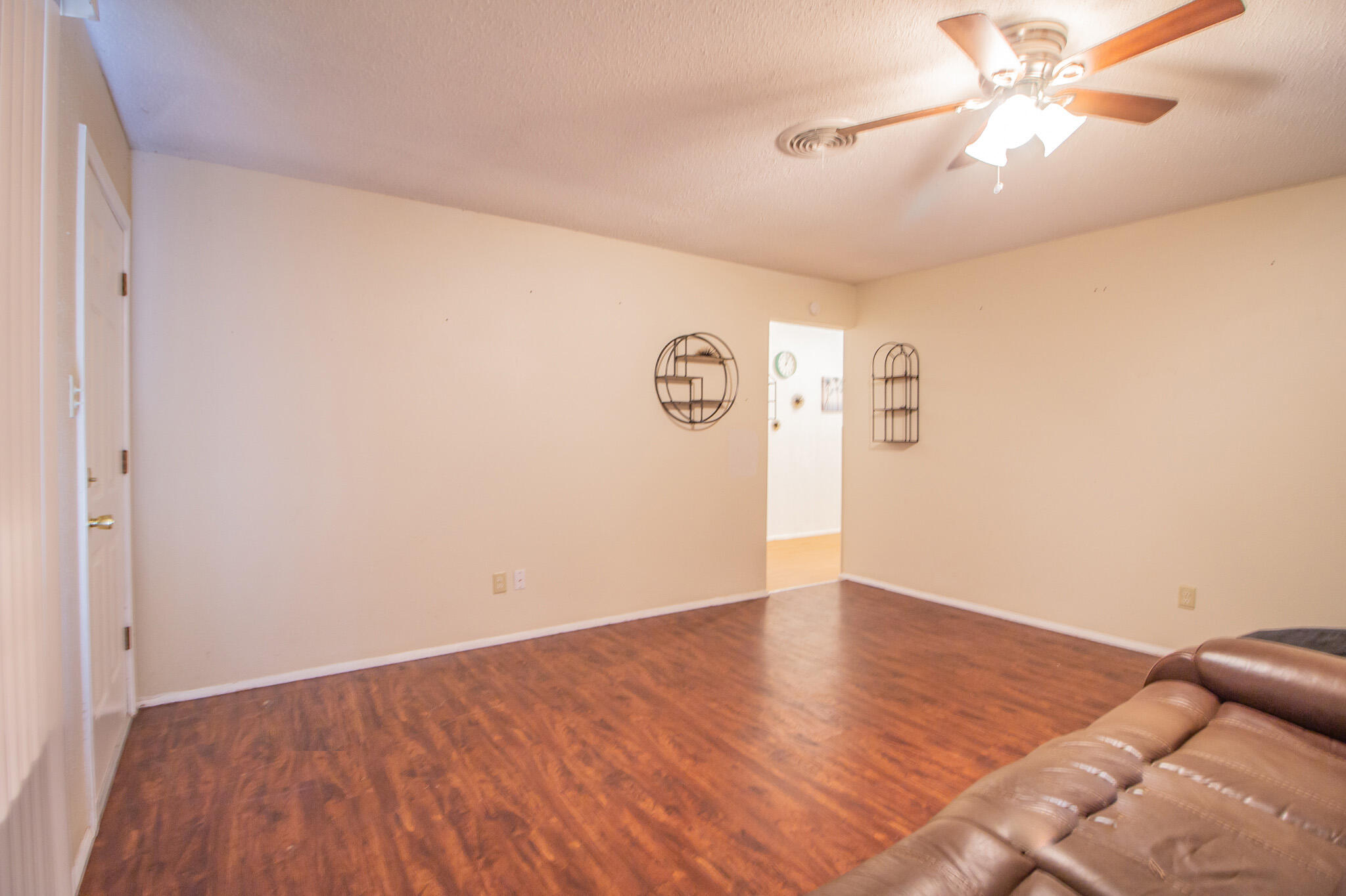 105 J B Avenue Floydada, TX 79235 - Photo 5 of 20 wooden floor in a empty room