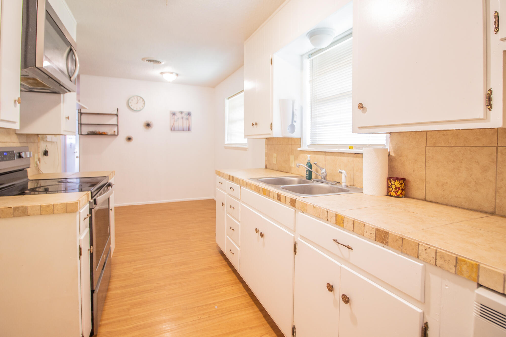 105 J B Avenue Floydada, TX 79235 - Photo 8 of 20 a large kitchen with a sink a stove and a refrigerator