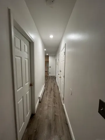 a view of hallway with wooden floor