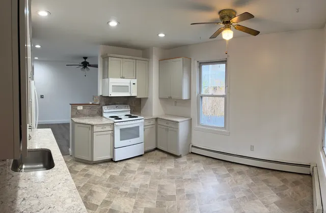 a kitchen with a stove a sink and a refrigerator