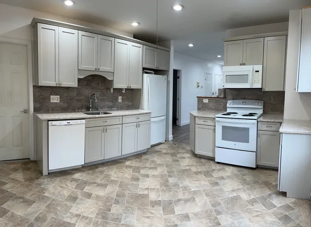 a kitchen with a stove a sink and a refrigerator