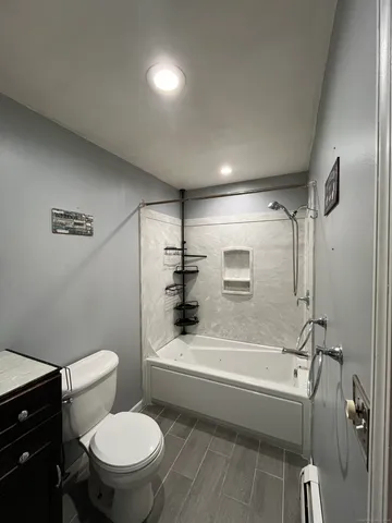a bathroom with a toilet and a bathtub