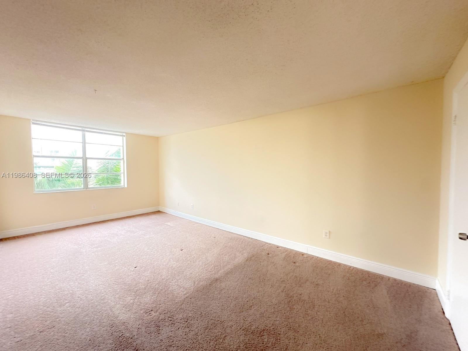 484 Northwest 165th St Road, Unit A412 Miami, FL 33169 - Photo 14 of 22 an empty room with windows