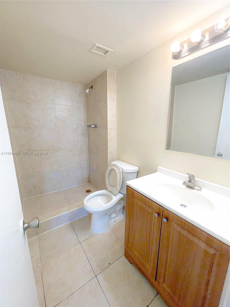 484 Northwest 165th St Road, Unit A412 Miami, FL 33169 - Photo 17 of 22 a bathroom with a sink a toilet and shower