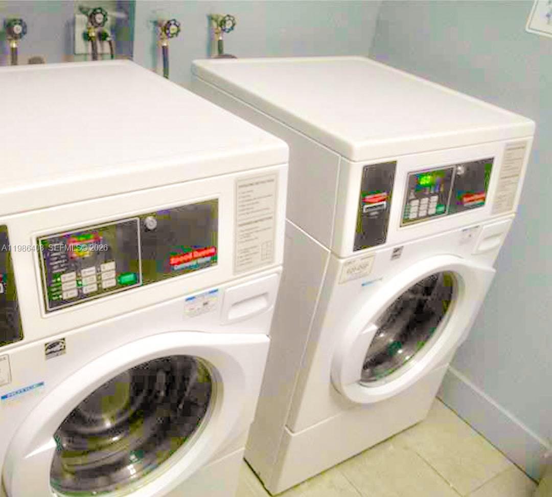 484 Northwest 165th St Road, Unit A412 Miami, FL 33169 - Photo 18 of 22 a utility room with dryer and washer