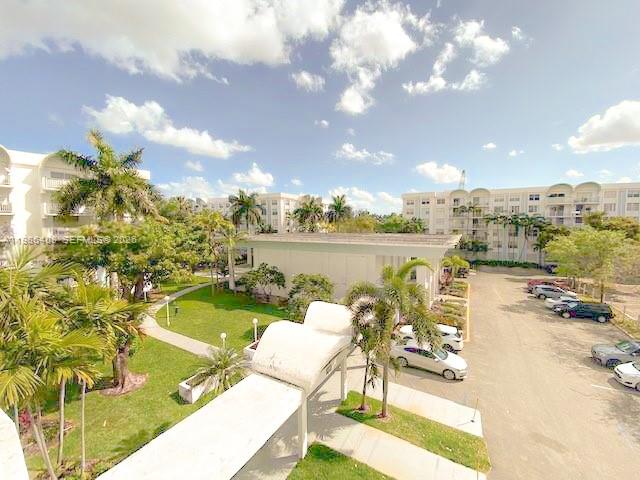 484 Northwest 165th St Road, Unit A412 Miami, FL 33169 - Photo 6 of 22 a view of a swimming pool with an outdoor seating