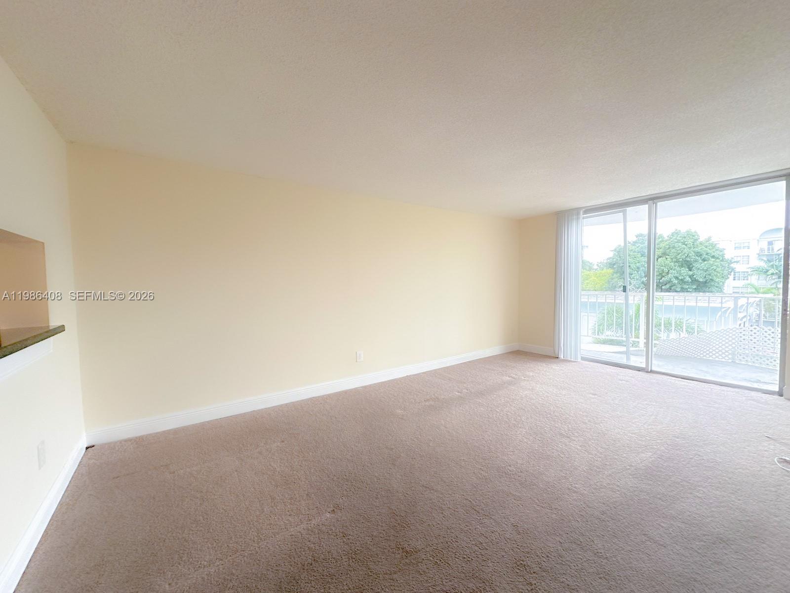 484 Northwest 165th St Road, Unit A412 Miami, FL 33169 - Photo 9 of 22 a view of an empty room with a window