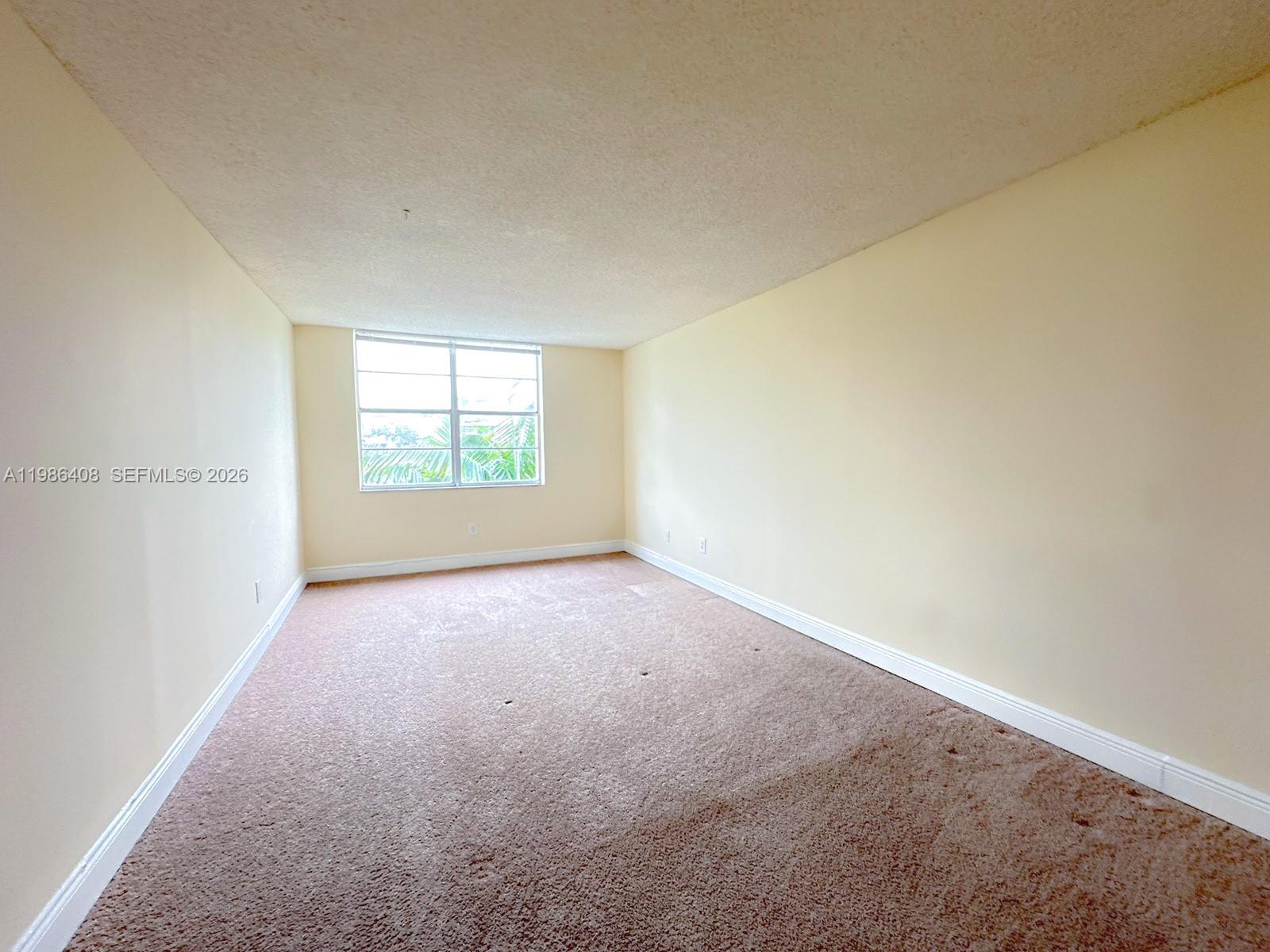 484 Northwest 165th St Road, Unit A412 Miami, FL 33169 - Photo 10 of 22 an empty room with windows