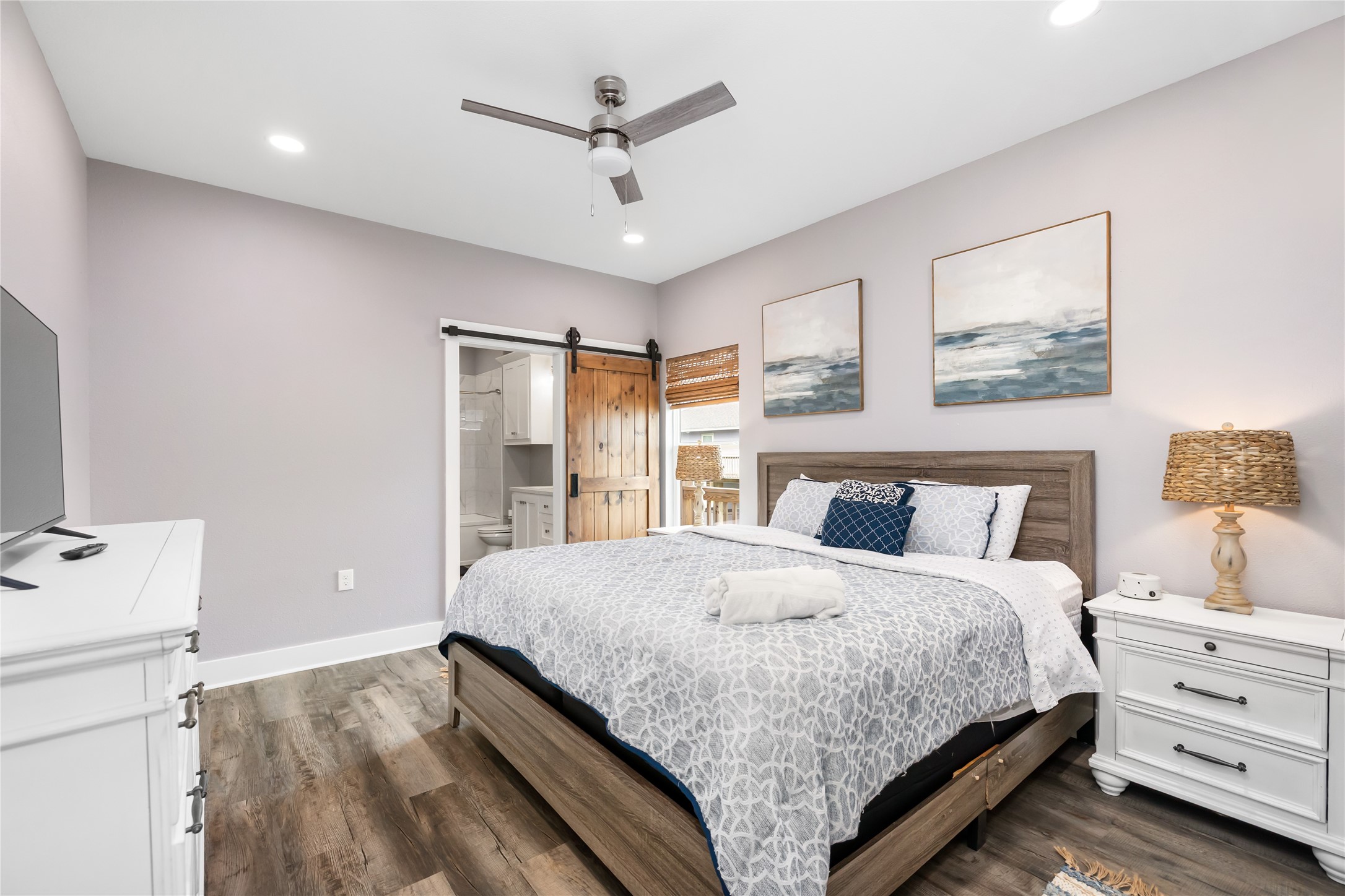 976 Albatros Crystal Beach, TX 77650 - Photo 13 of 30 a bedroom with a large bed and a chandelier