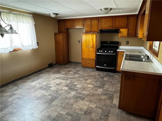 a kitchen with a refrigerator stove and a sink