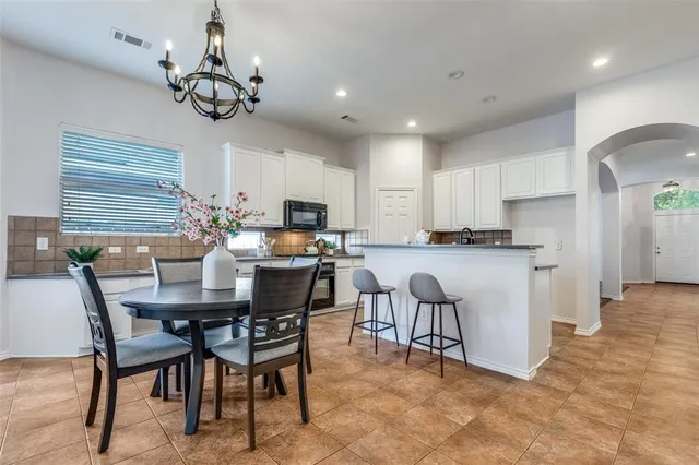 a view of a dining room with furniture and chandelier