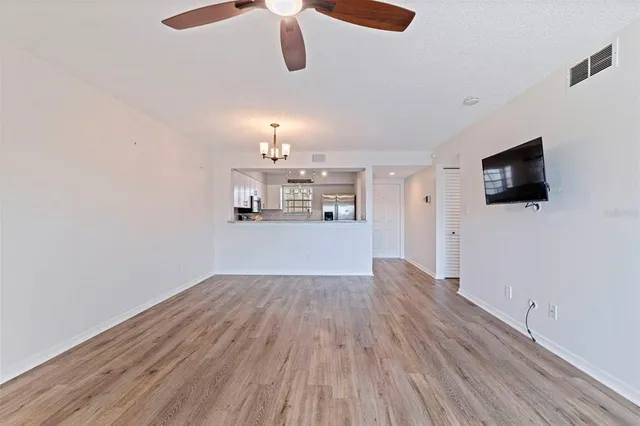 a view of a livingroom with wooden floor and a flat screen tv