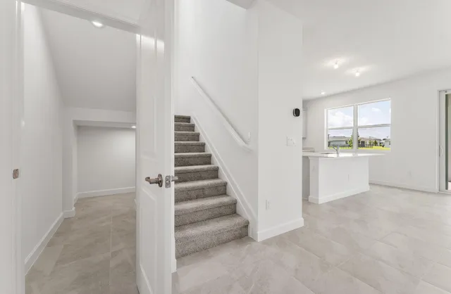 a view of a hallway with kitchen and entryway