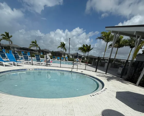 a view of a swimming pool with a lawn chairs