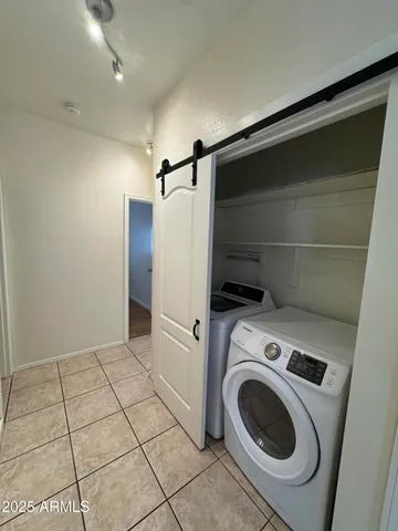 a view of a room with wooden floor and a ceiling fan