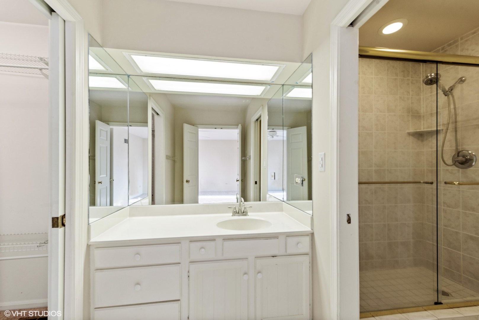 154 Timber Ridge Lane Lake Barrington, IL 60010 - Photo 16 of 26 a bathroom with a shower sink and mirror