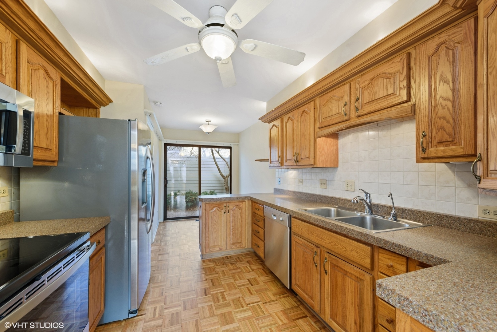 154 Timber Ridge Lane Lake Barrington, IL 60010 - Photo 6 of 26 a kitchen with stainless steel appliances granite countertop a sink and dishwasher a stove top oven with wooden floor