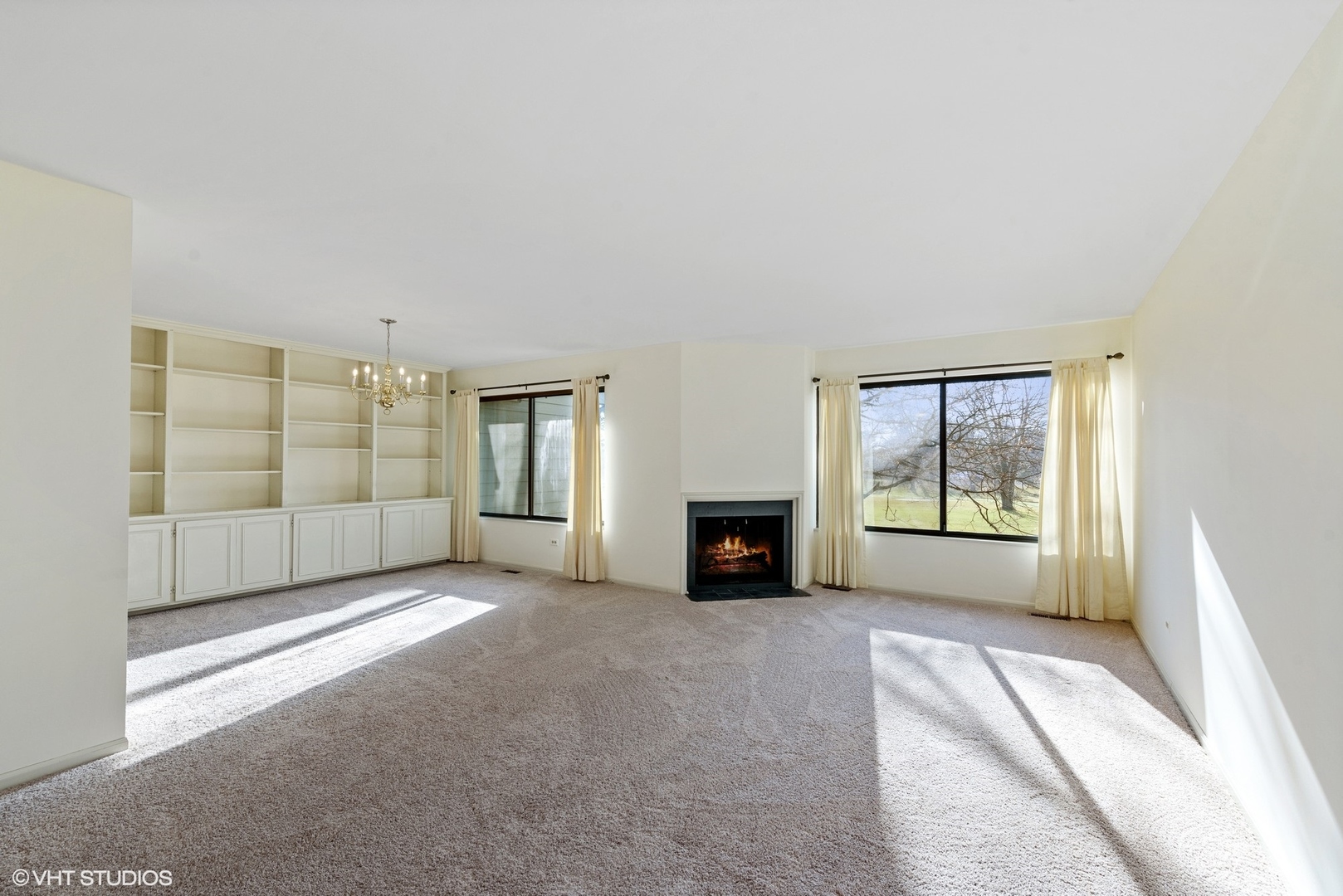154 Timber Ridge Lane Lake Barrington, IL 60010 - Photo 8 of 26 a view of an empty room with a fireplace and a window