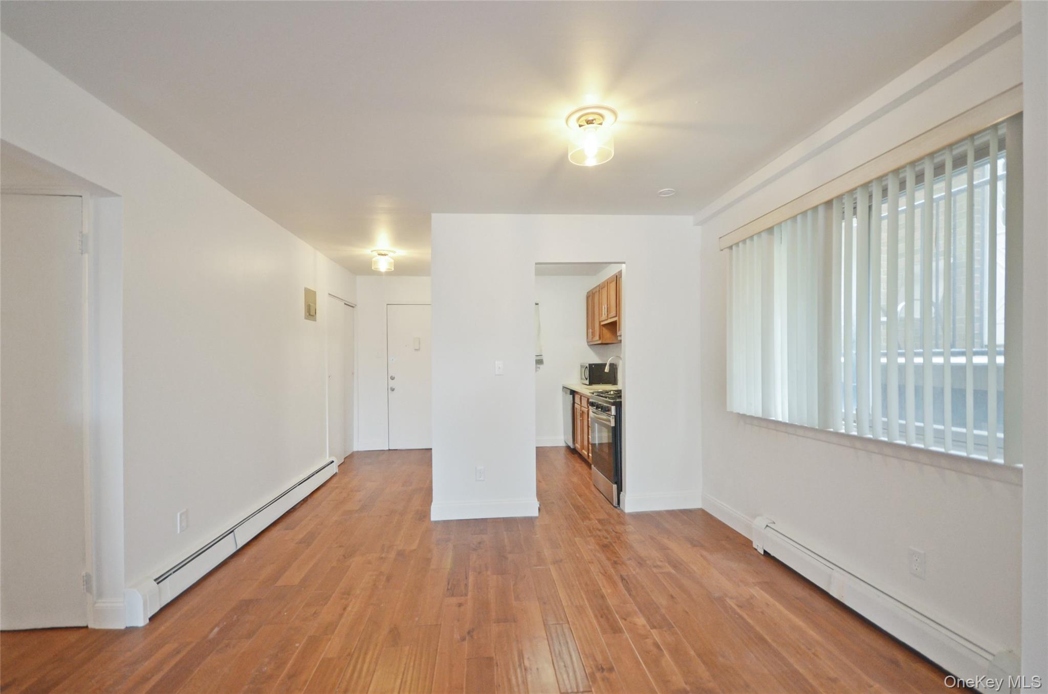 437 Palisade Avenue, Unit F1 Yonkers, NY 10703 - Photo 3 of 12 a view of a big room with wooden floor and windows
