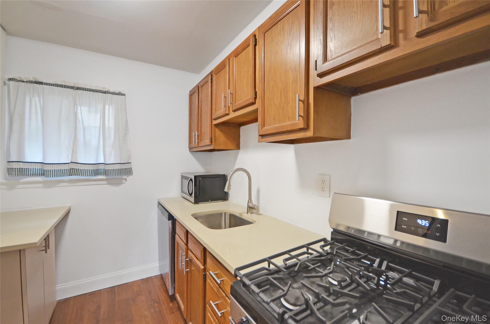 437 Palisade Avenue, Unit F1 Yonkers, NY 10703 - Photo 5 of 12 a kitchen with stainless steel appliances granite countertop a sink stove and cabinets