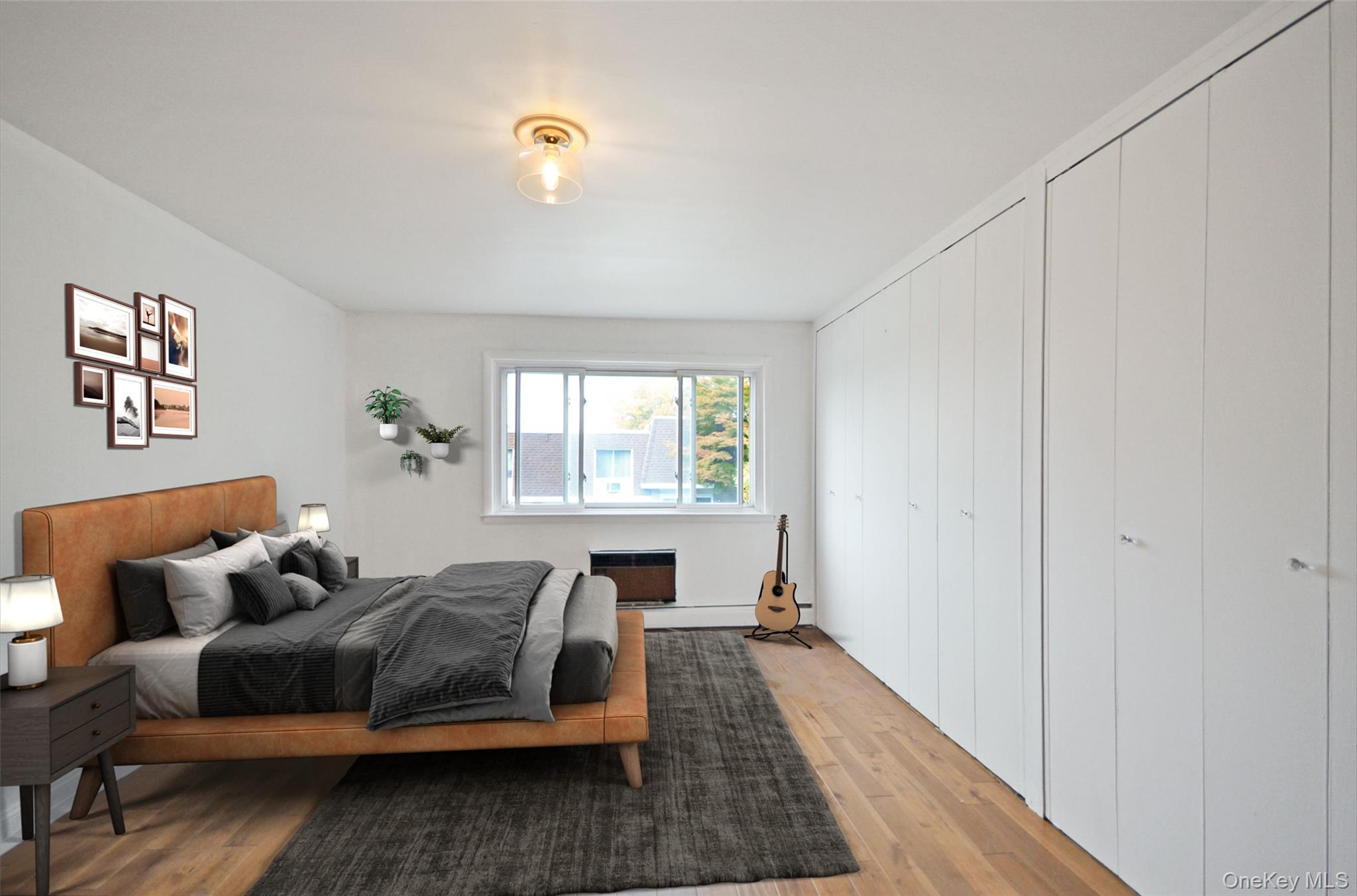 437 Palisade Avenue, Unit F1 Yonkers, NY 10703 - Photo 8 of 12 a spacious bedroom with a bed and wooden floor