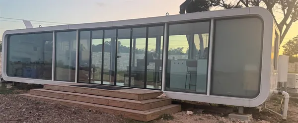 a backyard of a house with garden and outdoor seating