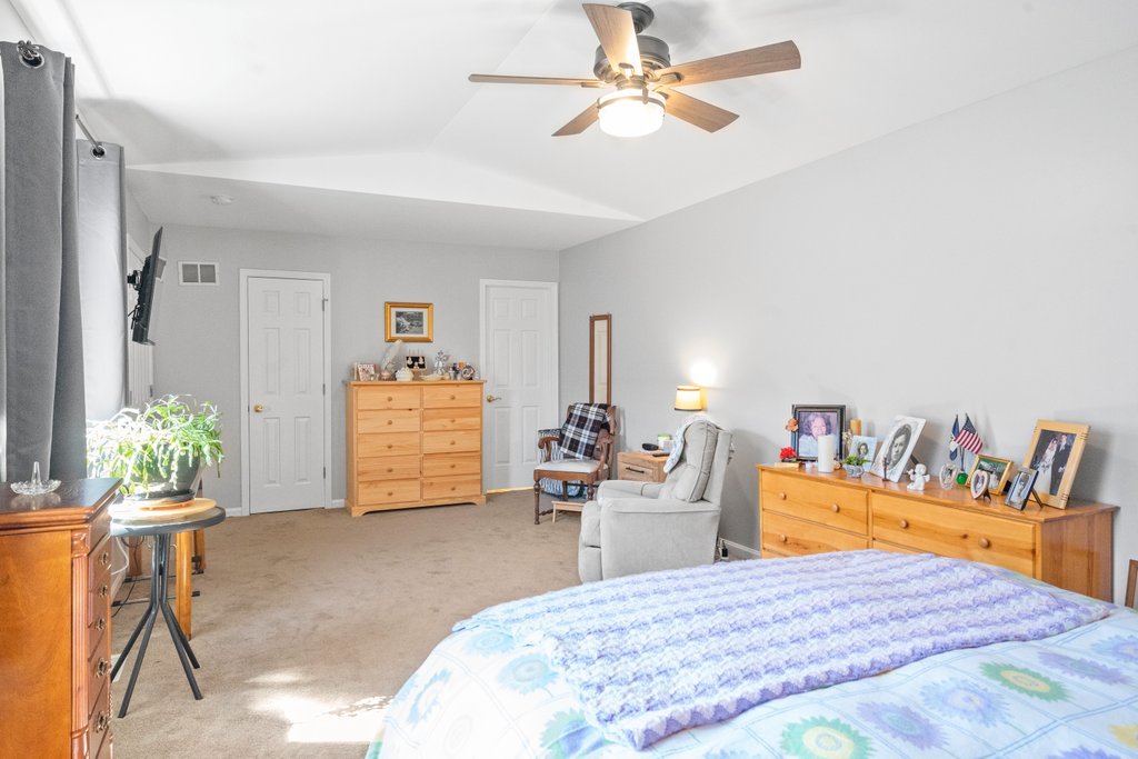 278 Charlotte Court Cary, IL 60013 - Photo 15 of 20 a bedroom with a bed and a chandelier